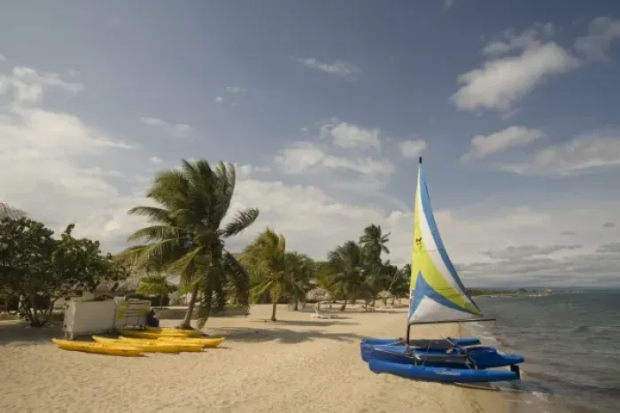 Framed Print : Hobiecat sailboat and kayaks on beach with palm trees by Caribbean Sea, Jaguar Reef Lodge Framed Print : Hobiecat sailboat and kayaks on beach with palm trees by Caribbean Sea, Jaguar Reef Lodge