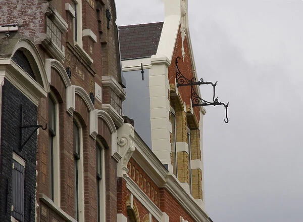 Hooks hanging from brick building in Amsterdam for pully system