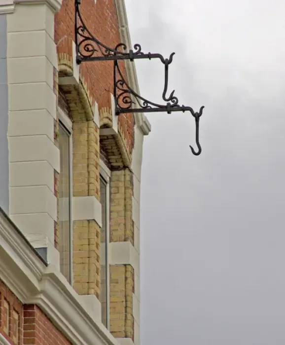 Framed Print : Hooks hanging from brick building in Amsterdam for pully system Framed Print : Hooks hanging from brick building in Amsterdam for pully system