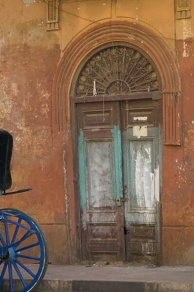 Horse Drawn Cart parked along the market in Luxor with an old doorway as backdrop, Egypt