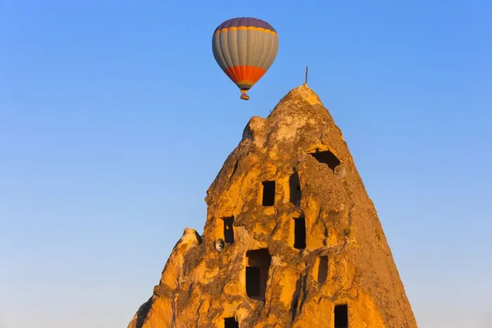 Framed Print : Hot air balloon over houses carved into rock formations, Uchisar, Cappadocia, Turkey Framed Print : Hot air balloon over houses carved into rock formations, Uchisar, Cappadocia, Turkey