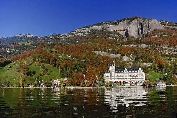 Hotel in autum along shore of Lake Lucerne from sightseeing boat, Lake Lucerne, Switzerland