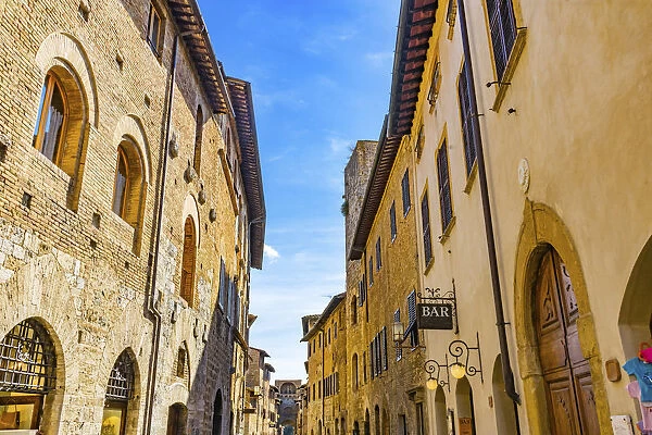 Hotel and bars on Medieval street, San Gimignano, Tuscany, Italy