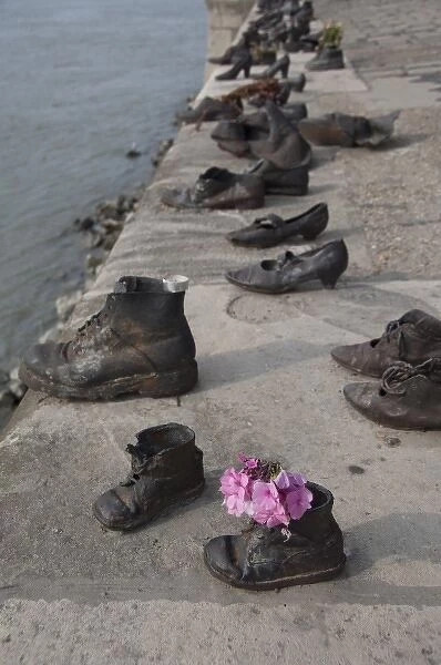Hungary, Budapest. Copper shoes along Danube River in memory of Jews who were shot
