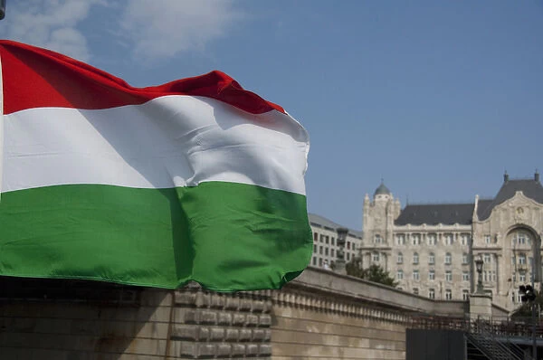 Hungary, capital city of Budapest. Hungarian flag in front of historic building