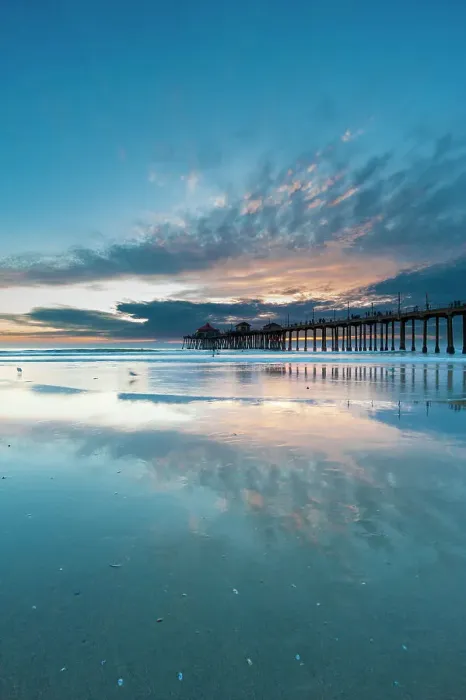 Framed Print : The Huntington Beach Pier and reflections on the wet beach at sunset. Huntington Beach, California