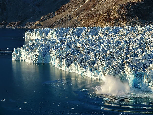 Ice calving. Knud Rasmussen Glacier (also called Apuseeq Glacier) in Sermiligaaq Fjord, Ammassalik, Danish Territory