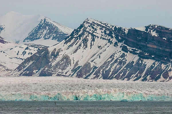 Ice capped mountains and a glacier border Kongsfjorden near Ny-Alesund, Kongsfjorden, Spitsbergen Island, Svalbard, Norway