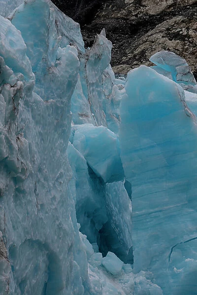 Ice glows brilliant blue at the terminus of Margerie Glacier