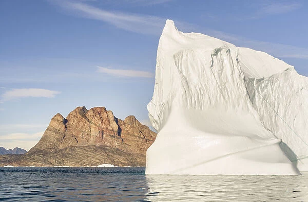 Iceberg in the Uummannaq Fjord System. Uummannaq Island in the background