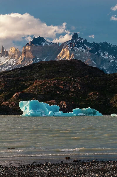 Icebergs floating in the Grey Lake with Torres del Paine in the background. Ultima Esperanza, Chile