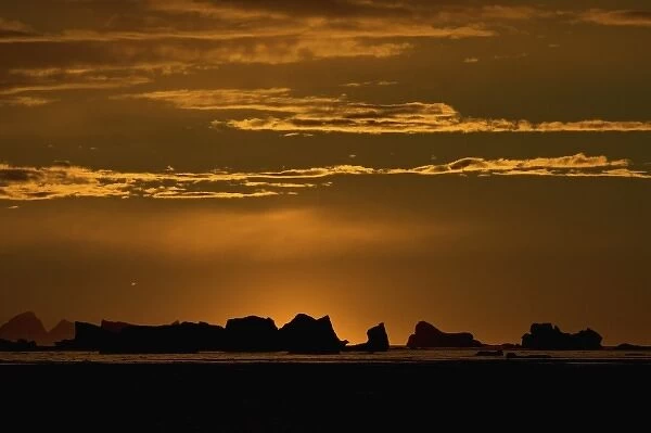 icebergs silhouetted at sunset, off the western Antarctic peninsula, Antarctica