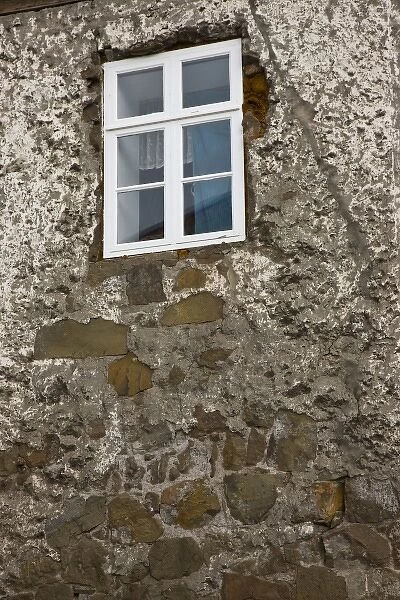 Iceland, Akureyri. Close-up of window of an old stone house