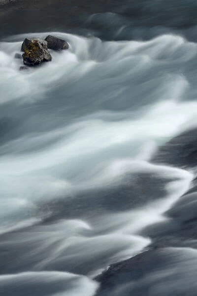 Iceland, Hraunfossar, Hvita River. The Hvita River flow quickly, creating patterns