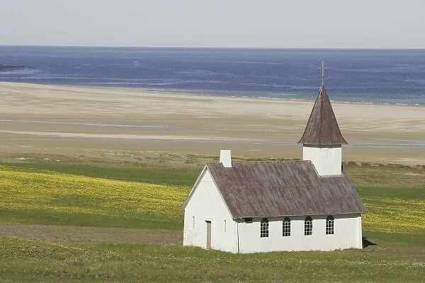 Iceland. An isolated Christian church near ocean beach