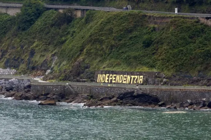 Framed Print : Independentzia painted on a rock wall by Basque separatists across the harbor from Ondarroa