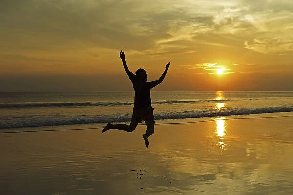 India, Andaman Islands, Havelock, beach number 7, shadow of man jumping at sunset