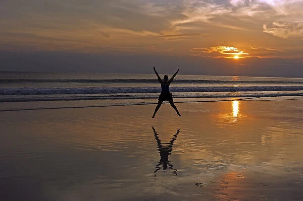 India, Andaman Islands, Havelock, beach number 7, shadow of woman jumping at sunset