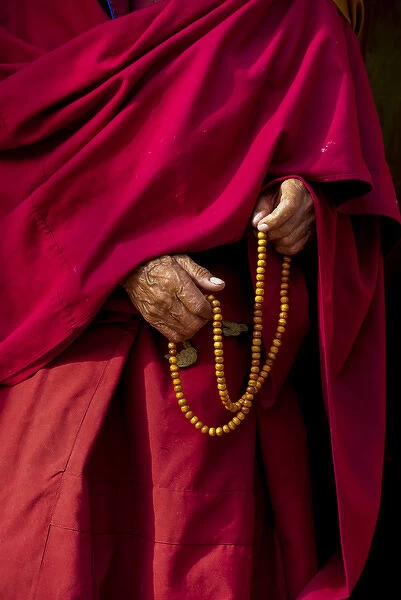 India, Jammu & Kashmir, Ladakh, Leh, capital of Ladakh hands of a monk in red holding