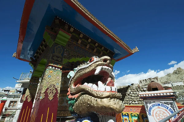 India, Ladakh, Leh, small colorful buddhist temple with dragon figure and Leh Palace