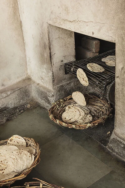 India, Punjab, Amritsar. Chapati coming out of oven at the Golden Temple, where 80