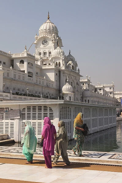 India, Punjab, Amritsar. Pilgrims walking at Golden Temple