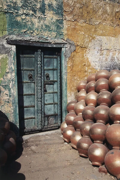 India, Rajasthan, Ceramic pot shop with iron doorway in background