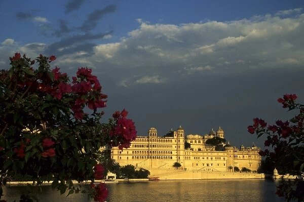 India, Rajasthan, Udaipur. View of City Palace, now a museum from Lake Palace Hotel on Pichola Lake