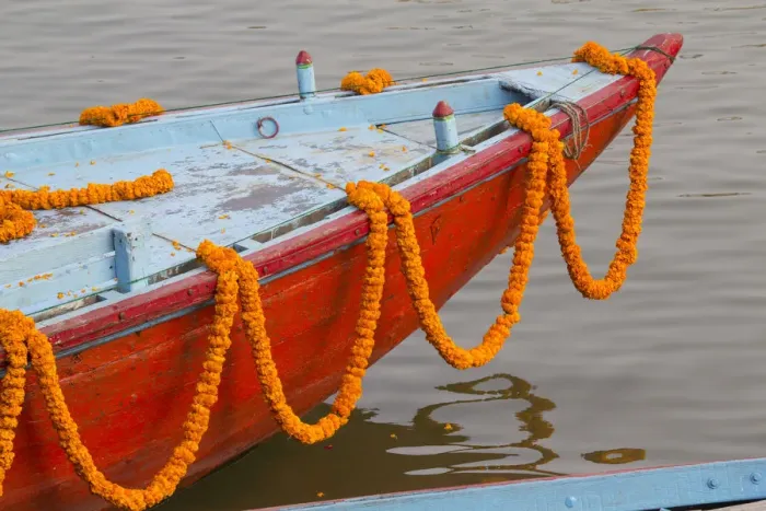 Framed Print : India, Uttar Pradesh, Varanasi. garlands of marigold adorn a small boat headed out Framed Print : India, Uttar Pradesh, Varanasi. garlands of marigold adorn a small boat headed out