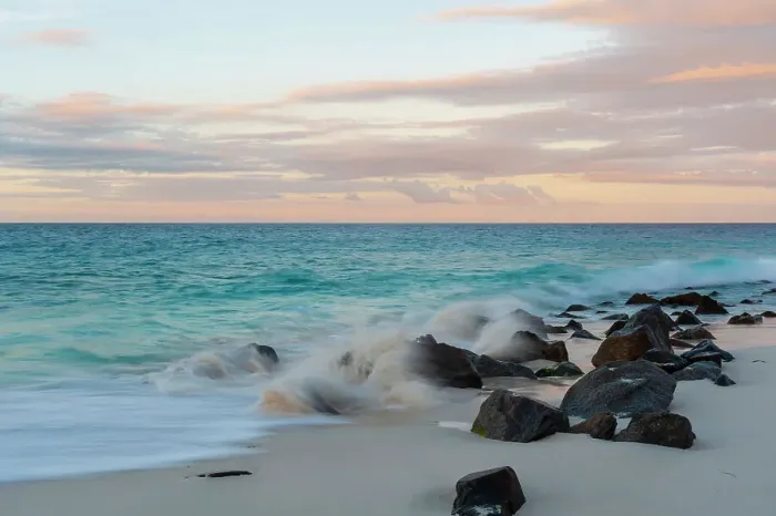 Framed Print : Indian Ocean surf crashing on to rocks on a tropical beach at sunset. Anse Bambous Beach, Fregate Island, Seychelles