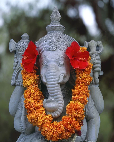 Indonesia, Bali. Garland on statue of the Hindu elephant god, Ganesh