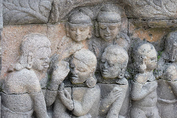Indonesia, Java, Borobudur. Largest Buddhist monument in the world. UNESCO. Detail of carved stone figures in the hidden foot