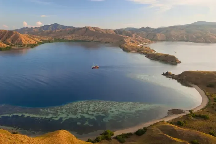 Framed Print : Indonesia, Komodo National Park. A phinisi schooner brings divers into a harbor. Credit as Framed Print : Indonesia, Komodo National Park. A phinisi schooner brings divers into a harbor. Credit as