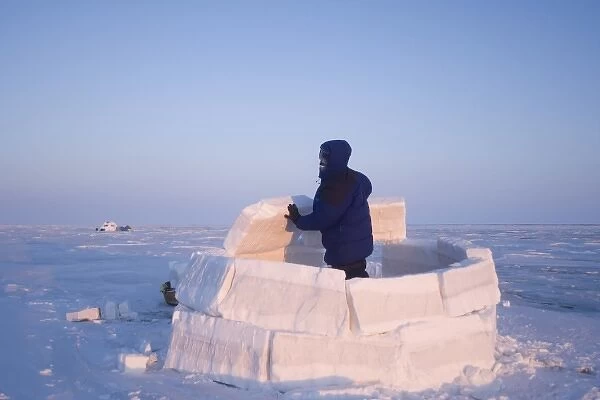 inupiat guide Bruce Inglangasak building an igloo snow blind, along the Arctic coast