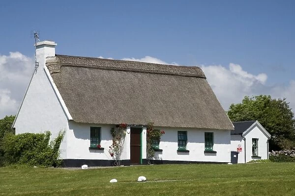 Ireland, Ballyvaughan. Traditional thatched-roof cottage