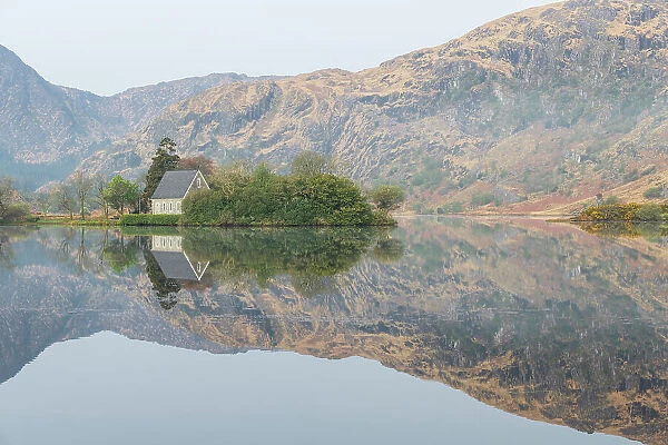Ireland, Cork, Gougane Barra. Church and mountain reflections in lake