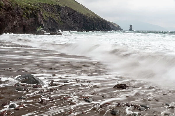 Ireland, County Kerry, Dunmore Head. Cliff and wave on ocean and beach