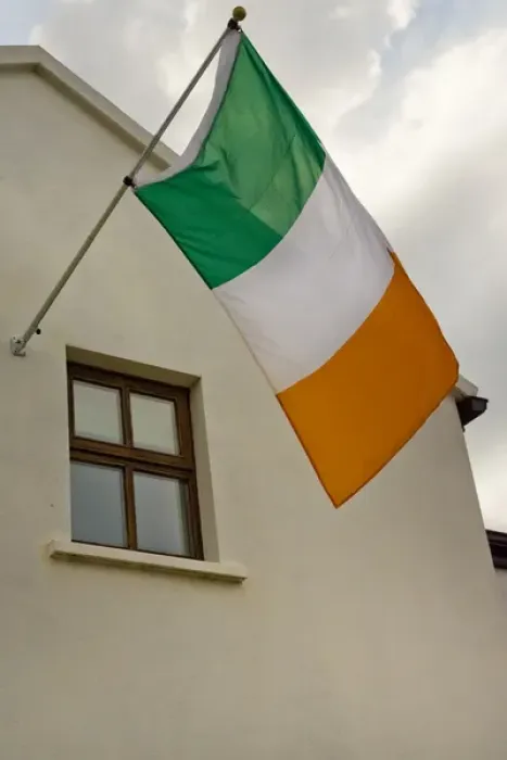 Framed Print : Ireland, County Mayo, Achill Island, Dooagh. The flag of Ireland flies from building