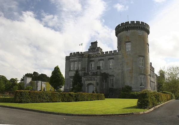 In Ireland, the Dromoland Castle side entrance and turret blue sky white clouds