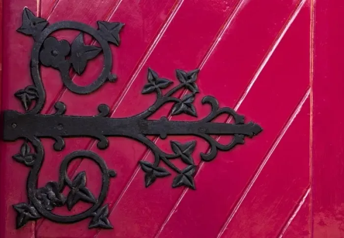 Framed Print : Ireland, Ennis. A decorative black hinge on a bright red door of the new Franciscan Framed Print : Ireland, Ennis. A decorative black hinge on a bright red door of the new Franciscan