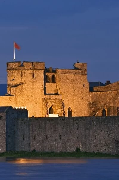 Ireland, Limerick. View of King Johns Castle and the River Shannon at night