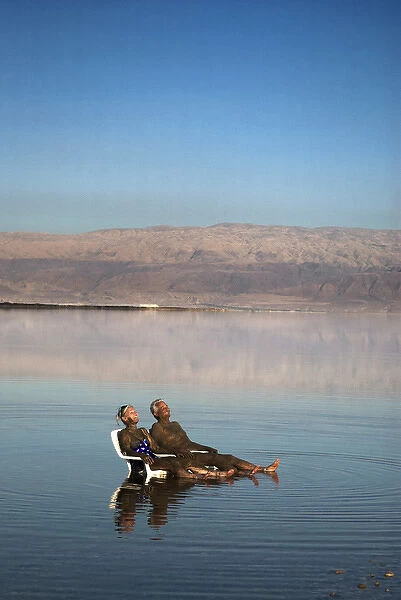 Israel; Dead Sea. A couple is covered in healing mud at the Dead Sea in Israel