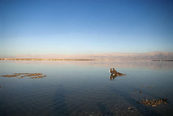 Israel; Dead Sea. A couple relaxes at the Dead Sea in Israel