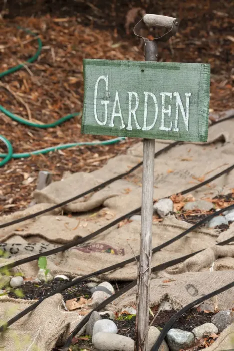 Framed Print : Issaquah, Washington State, USA. Garden sign and burlap bags covering dormant vegetable garden