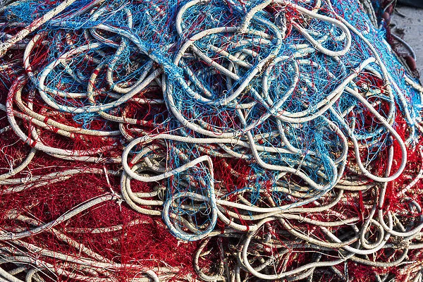 Italy, Apulia, Province of Lecce, Gallipoli. Texture detail of fishing nets in red, white