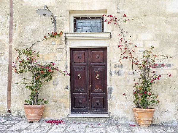 Italy, Basilicata, Matera. Flowers adorning the entrance of a Sassi house