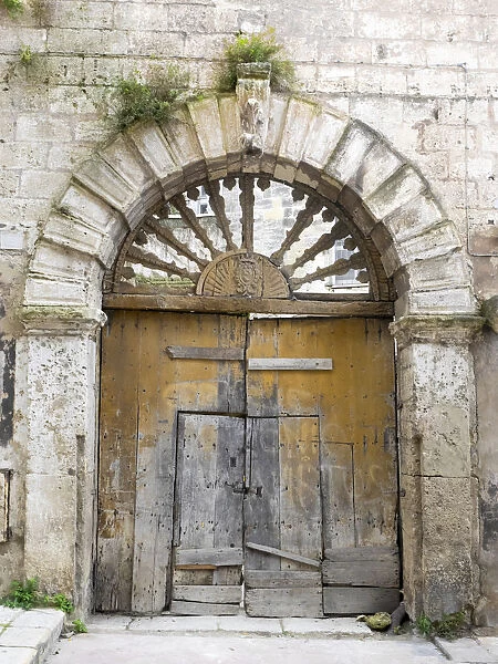 Italy, Basilicata, Matera. Old ornate wooden door in the old town of Matera