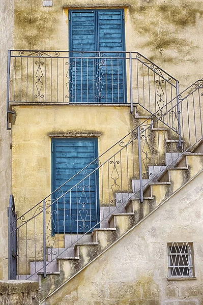 Italy, Basilicata, Matera. Stairs leading to blue doors and shutters in old town Matera