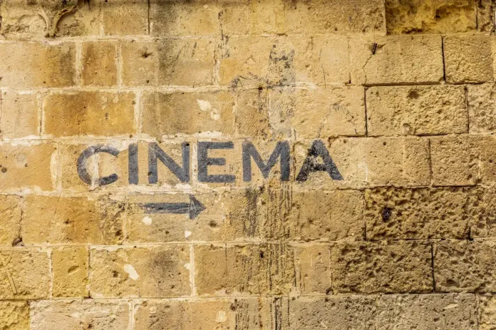 Framed Print : Italy, Basilicata, Province of Matera, Matera. Sign on a wall pointing to a cinema