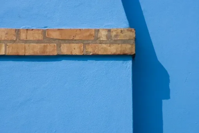 Framed Print : Italy, Burano. Close-up of blue stucco exterior of chimney and colored brick